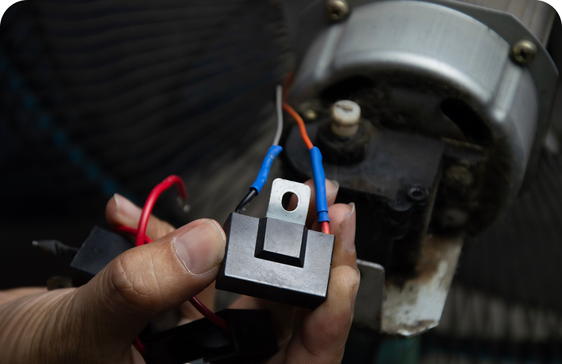 Electrical part being inspected by hand